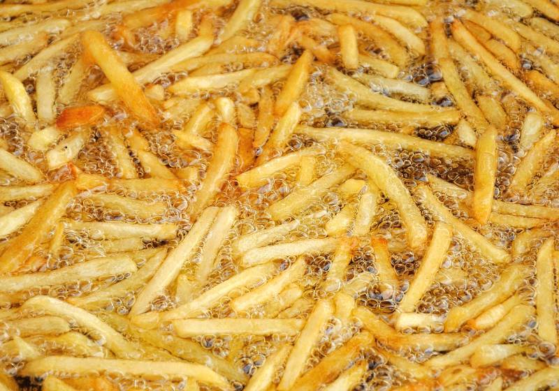 french fries frying with a deep fryer